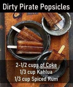 two cups of cake pops on a wooden table with text overlay that reads dirty pirate popsicles