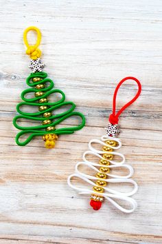 an ornament shaped like a christmas tree on top of a wooden table next to other ornaments