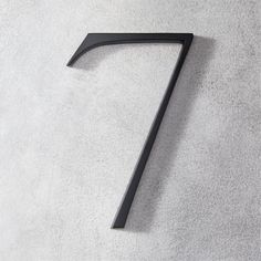 the number seven is made out of metal and has a black finish on it's surface