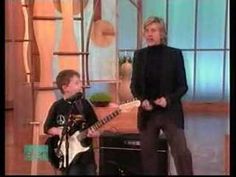 two young boys are playing guitars on the television show