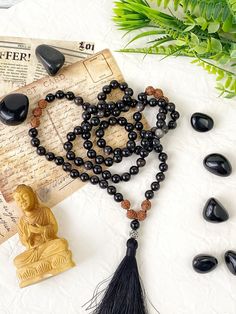 This elegant mala necklace is made with 108 natural stone 8mm beads of obsidian and rudraksha beads. It's a very special gifts for yoga lovers. This prayer garland  is the perfect support garland for counting mantras during your practices. Its a 108 8mms beads mala, very light weight and delicate, a spiritual sacred jewelry for chakra healing. All our malas are very versatile, since you can use them on many occasions.hanging from the neck, with a turn or two or on the wrist, with several turns. Spiritual Stone jewels choose personally every single gemstone for her prayer garlands, to ensure his beauty and quality.  The mala collar comes from a long oriental spiritual tradition. All of our products are created to inspire you in your meditations and support you on your spiritual path. I make Black Obsidian Necklace With 108 Beads, Obsidian Beads Jewelry For Meditation, Obsidian 8mm Beads Jewelry For Meditation, Holistic Black Round Beaded Jewelry, Holistic Black Round Beads Jewelry, Black Gemstone Beads Mala For Healing, Handmade Black Mala For Meditation, Handmade Black Mala As Gift, Black Natural Stones Jewelry For Meditation