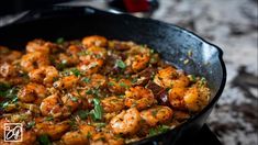 a skillet filled with shrimp and rice