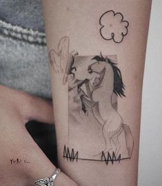 a woman with a horse tattoo on her arm