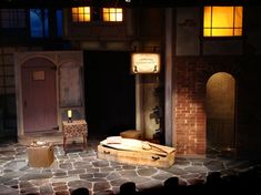 the stage is set for a play with an old suitcase and other items on it