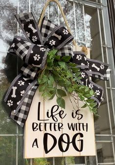 a dog door hanger that says life is better with a dog