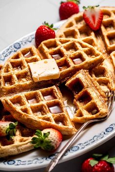 waffles with butter and strawberries on a plate