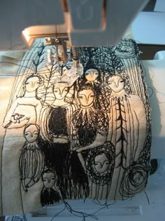 the sewing machine is working on an embroidered bag