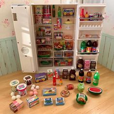 an open refrigerator filled with lots of food and condiments on top of a wooden table