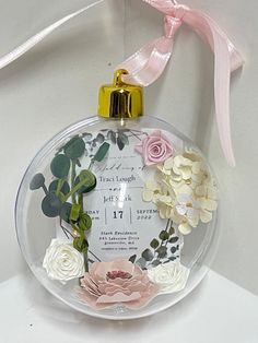 a glass ornament with flowers on it