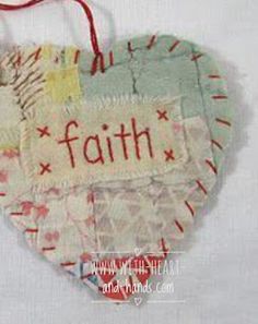 a heart shaped ornament with the word faith on it