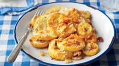 a white plate topped with potatoes covered in gravy