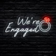 we're engaged neon sign against a brick wall