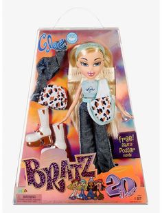 the barbie doll is in its box and has leopard print on her pants, boots, and hat