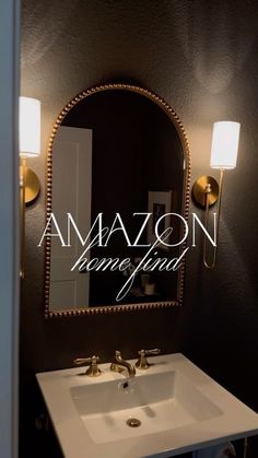 a bathroom sink sitting under a mirror next to a wall mounted faucet with the words amazon hanging on it