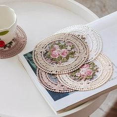 there is a cup and some doily on the table