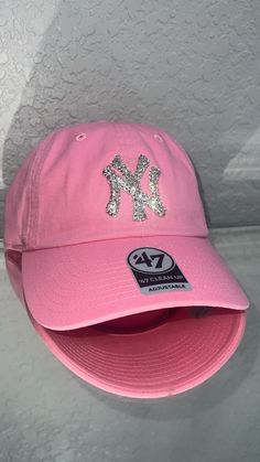 a pink new york yankees hat with sequins on it