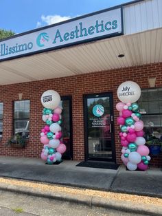 the front entrance of a dentist's office decorated with balloons