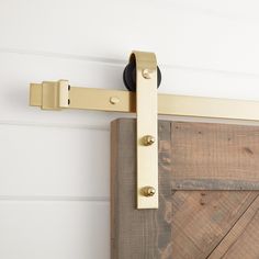 a close up of a wooden door with metal handles