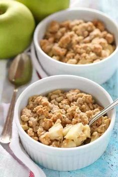 two white bowls filled with oatmeal next to green apples