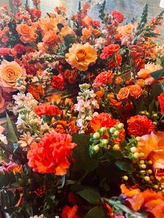 many different colored flowers are arranged together