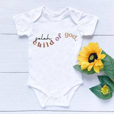 This bible verse is an amazing first baby onesie for your child or for a newborn in your family. The bible verse romper- I am a Child of God Baby Jumpsuit will get your little human preaching the word from day 1. What a joy! Soft Fabric for Baby. This jumpsuit is made of super soft cotton to protect the baby's tender skin. Convenience for Parents as it has Button up for easy diaper changes, you can dress up the baby in seconds. Please fill in your personalization detail correctly. Due to the nat Name Onesie, God Baby, Cute Onesies, Christian Shirts Designs, Bible Verses For Kids, Personalized Bible, Rompers For Kids, Child Of God