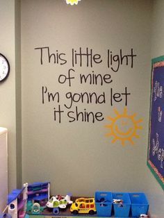 a child's playroom with toys on the floor and a wall that says, this little light of mine i'm going let it shine