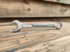 a wrench sitting on top of a wooden table