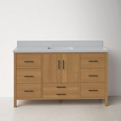 an image of a bathroom vanity with drawers and sink in it's center area