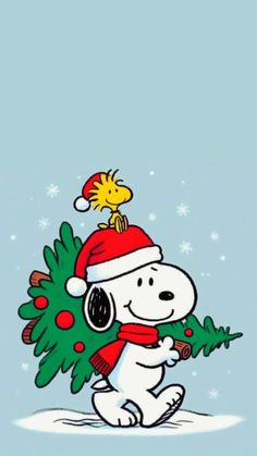 snoopy holding a christmas tree in his hand