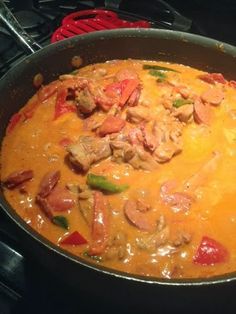 a pan filled with food sitting on top of a stove