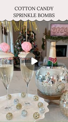 two champagne flutes sitting on top of a table next to disco balls and a mirror ball