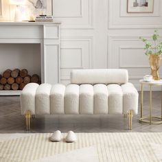 a white couch sitting in front of a fireplace