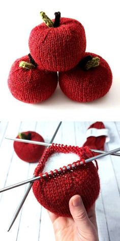 there is a red knitted apple with needles in the shape of apples on it