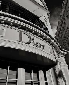 a black and white photo of a building with the word dior on it