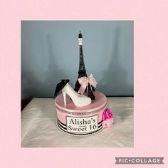 there is a pink cake with a shoe and eiffel tower on it