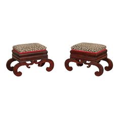 two wooden stools with leopard print cushions