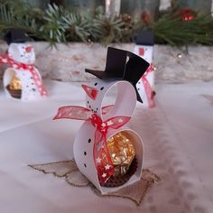 a snowman made out of candy in the shape of a heart and wearing a top hat