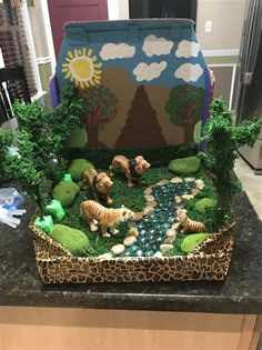 a box filled with fake animals sitting on top of a counter