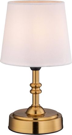 a gold table lamp with a white shade