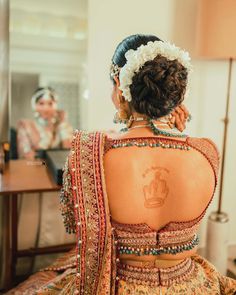 the back of a woman's dress in front of a mirror