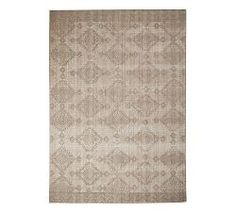 a beige rug with an intricate design on it