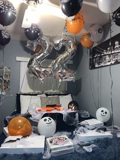 a bed with balloons and decorations on it