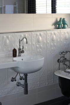 a white sink sitting next to a bath tub