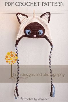 a crocheted cat hat hanging on the wall