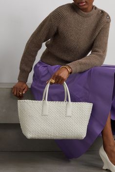 Bottega Veneta's 'Cabat' tote perfectly showcases the label's fine craftsmanship. Made from supple strips of leather using the signature intrecciato technique, this boxy and streamlined accessory has a spacious interior. Wear it with a tailored suit and statement pumps. Tailored Suit, Floral Dresses Short, Raffia Bag, Leather Weaving, Sports Suit, Everyday Wardrobe, Jeans Dress, Denim Fashion, Bottega Veneta