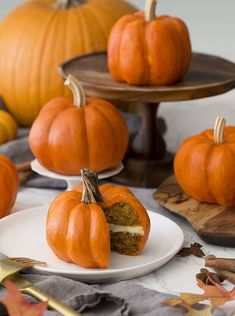 there are several pumpkins on the table with one half eaten cake in front of it