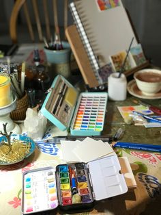 an assortment of art supplies sitting on top of a table