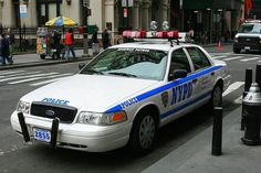 the police car is parked on the side of the street