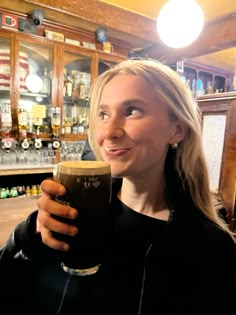 a woman holding a beer in her right hand