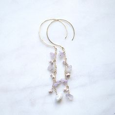 "Dainty Amethyst stones dangle from 2\" gold filled chains and hang from hammered 20g gold filled ear wires." Handmade 14k Gold Filled Dangle Linear Earrings, Gold Amethyst Long Drop Earrings, Gold Amethyst Dangle Chandelier Earrings, Gold Amethyst Chandelier Earrings As Gift, Lavender Dangle Earrings With Ear Wire, 14k Gold Filled Jewelry With Dangling Beads, 14k Gold-filled Jewelry With Dangling Beads, Lavender Dangle Jewelry With Dangling Beads, Amethyst Earrings Gold